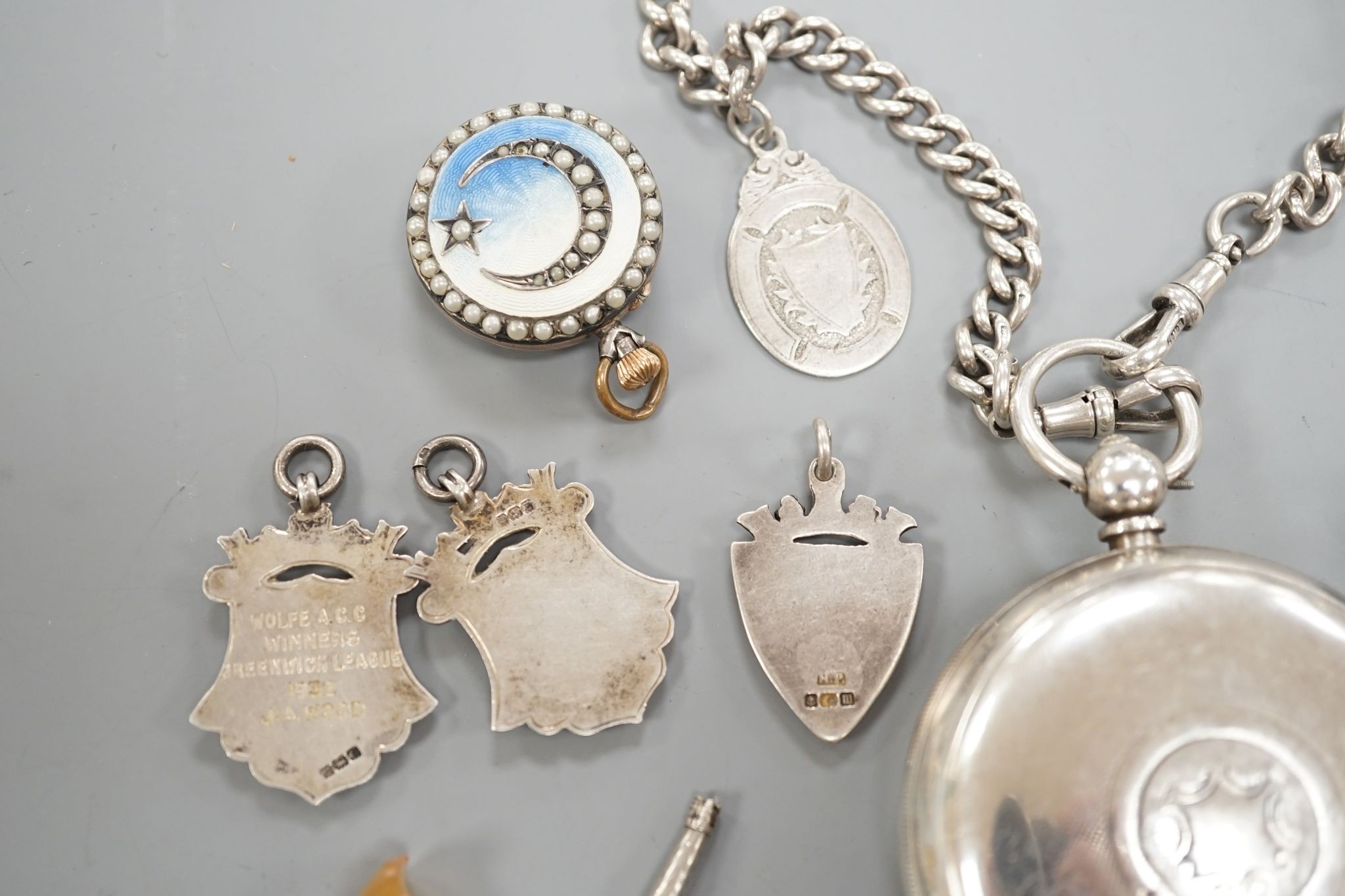 A George V silver open faced lever pocket watch, by A. Yewdall, Leeds, on a silver albert hung with silver medallions, two Swiss white metal and enamel fob watches, gilt fob seal, etc.